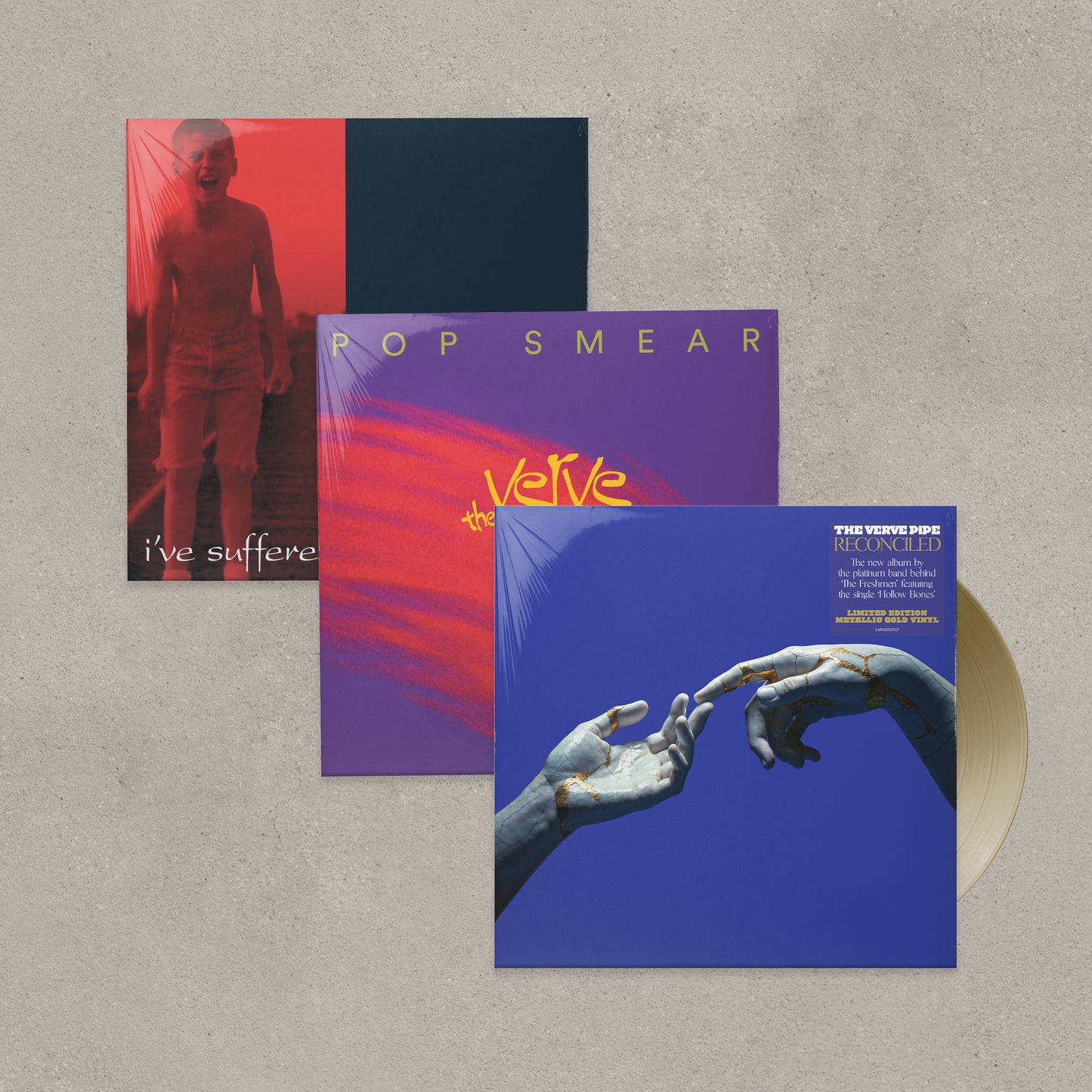 Three album covers on a textured surface